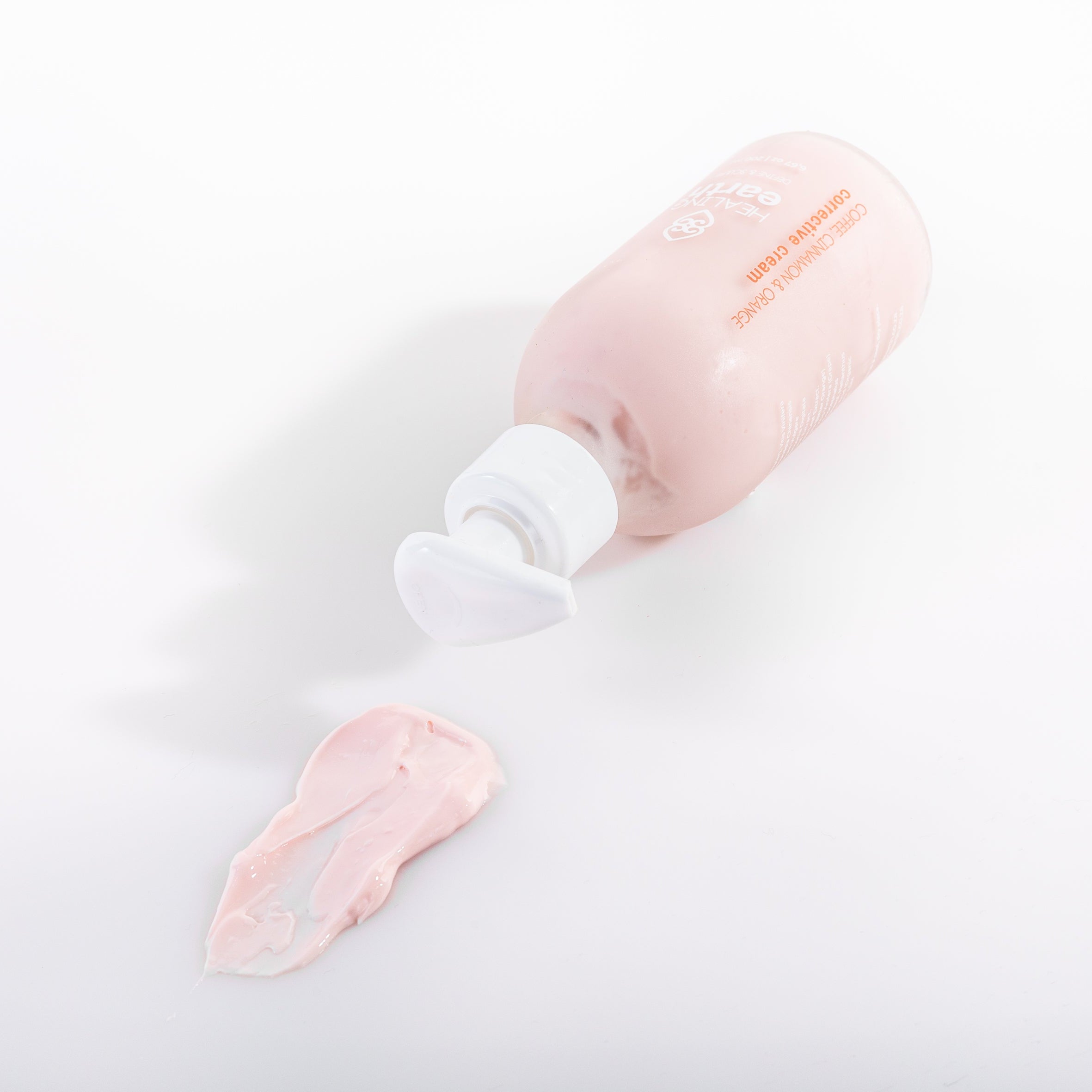 Pink Corrective Cream with swatch on a light gray background